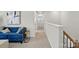 Upstairs hallway with modern decor, a blue sofa, and views of the staircase at 604 Cassidy Ct, Clover, SC 29710