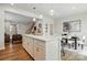 Bright kitchen boasts an island with white cabinets, quartz countertops, and modern pendant lighting at 604 Cassidy Ct, Clover, SC 29710
