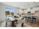 Open-concept kitchen and dining area with a large window, island seating, and stylish pendant lights at 604 Cassidy Ct, Clover, SC 29710
