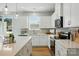 Well-lit kitchen boasts stainless appliances, white cabinetry, and ample counter space at 604 Cassidy Ct, Clover, SC 29710