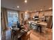 Modern kitchen with stainless steel appliances, granite counters, an island, and an adjacent dining area at 604 Cassidy Ct, Clover, SC 29710