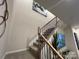 Carpeted staircase with wooden railings, leading to the upper level of the home, with visible artwork on the wall at 616 Cassidy Ct, Clover, SC 29710