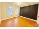 Bedroom with hardwood floors and accent wall at 6726 Mallard Park Dr, Charlotte, NC 28262