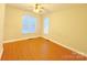 Bright bedroom featuring hardwood floors and large windows at 6726 Mallard Park Dr, Charlotte, NC 28262