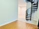 Light-filled living room with wood floors and spiral staircase at 6726 Mallard Park Dr, Charlotte, NC 28262
