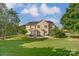 Expansive backyard featuring a spacious patio, lush green lawn, and mature trees, perfect for outdoor activities at 712 Springwood Dr, Waxhaw, NC 28173