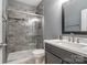 Modern bathroom with glass-enclosed tiled shower and sleek vanity with a white countertop at 712 Springwood Dr, Waxhaw, NC 28173