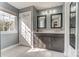 Bathroom with double sinks, granite counters, white door, and marble flooring at 712 Springwood Dr, Waxhaw, NC 28173
