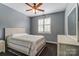 Well-lit bedroom with hardwood floors, ceiling fan, and a window with plantation shutters at 712 Springwood Dr, Waxhaw, NC 28173