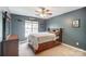 Comfortable bedroom with ceiling fan, natural light, and carpeted floors at 712 Springwood Dr, Waxhaw, NC 28173