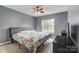 Large bedroom with a ceiling fan, a bed and a large window at 712 Springwood Dr, Waxhaw, NC 28173
