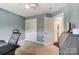 Bright bedroom with a desk, carpeted floors, and ensuite bathroom at 712 Springwood Dr, Waxhaw, NC 28173