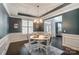 Elegant dining room with dark hardwood floors, wainscoting, and a stylish chandelier at 712 Springwood Dr, Waxhaw, NC 28173
