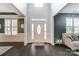Elegant foyer featuring dark hardwood floors, a bright white door, and neutral paint colors at 712 Springwood Dr, Waxhaw, NC 28173