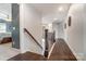Upper hallway with hardwood floors, decorative railing and access to bedrooms at 712 Springwood Dr, Waxhaw, NC 28173
