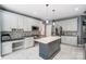 Bright kitchen featuring an island, white cabinets, and stainless steel appliances at 712 Springwood Dr, Waxhaw, NC 28173