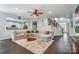 Spacious living room with hardwood floors, a large sectional, and view to the kitchen at 712 Springwood Dr, Waxhaw, NC 28173