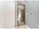 Bathroom with glass shower door, light blue walls, and gray marble details at 712 Springwood Dr, Waxhaw, NC 28173