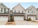 Street view of charming two-story homes with stone and siding exteriors and two-car garages at 7552 Hartsfield Dr, Lancaster, SC 29720