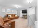 Upstairs living room with comfortable seating, a media center, and natural light, ideal for relaxing and entertaining at 7552 Hartsfield Dr, Lancaster, SC 29720