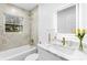 Clean bathroom with white vanity, bathtub, and marble-look tile at 809 Miller St, Gastonia, NC 28052