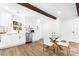 Updated kitchen with white cabinets, stainless steel appliances, and glass dining table at 809 Miller St, Gastonia, NC 28052