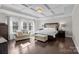This primary bedroom features a tray ceiling, hardwood floors, and is brightly lit by natural light at 840 Pecan Tree Ln, Fort Mill, SC 29715