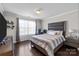 This modern bedroom has hardwood floors, a TV, and a large window at 840 Pecan Tree Ln, Fort Mill, SC 29715