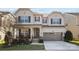 Charming two-story home featuring a covered front porch and a two-car garage at 840 Pecan Tree Ln, Fort Mill, SC 29715