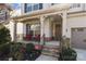Welcoming front porch with seating area and elegant stone-accented entryway at 840 Pecan Tree Ln, Fort Mill, SC 29715