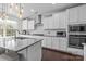 Gourmet kitchen with granite counters, stainless steel appliances, subway tile, and breakfast bar island at 840 Pecan Tree Ln, Fort Mill, SC 29715