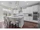 Gourmet kitchen with granite counters, stainless appliances, pendant lights, and breakfast bar seating at 840 Pecan Tree Ln, Fort Mill, SC 29715