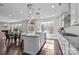 Modern kitchen featuring granite counters, stainless appliances, and an open layout to dining area at 840 Pecan Tree Ln, Fort Mill, SC 29715