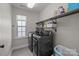This laundry room has a washer and dryer with overhead shelves at 840 Pecan Tree Ln, Fort Mill, SC 29715