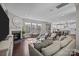 Open concept living room with fireplace, large windows, and seamless flow to the kitchen at 840 Pecan Tree Ln, Fort Mill, SC 29715