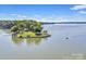 Scenic aerial view of an island property surrounded by calm waters and lush vegetation at 1077 Gauguin Ln, Tega Cay, SC 29708