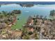 Beautiful aerial view of lakeside home with private docks on Lake Wylie in a wooded setting at 1077 Gauguin Ln, Tega Cay, SC 29708