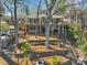 Exterior of home with a large porch, landscaped yard, fire pit, and stairs to the dock at 1077 Gauguin Ln, Tega Cay, SC 29708