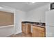 Wet bar features granite counters and light wood cabinets at 1077 Gauguin Ln, Tega Cay, SC 29708