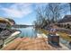 A dock on a lake, complete with boat and furnishings, presents an idyllic waterfront lifestyle at 1077 Gauguin Ln, Tega Cay, SC 29708