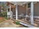 Charming front porch with rocking chairs, creating a welcoming entrance to the home at 1077 Gauguin Ln, Tega Cay, SC 29708
