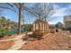Charming greenhouse with a waterfront view, surrounded by serene landscaping, and a glimpse of the lake at 1077 Gauguin Ln, Tega Cay, SC 29708