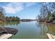 Peaceful view of the lake from the boat dock, calm water, and wooded shore line at 1077 Gauguin Ln, Tega Cay, SC 29708