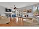 Bright living room with hardwood floors, fireplace, ceiling fan, and lake view at 1077 Gauguin Ln, Tega Cay, SC 29708