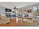 Bright living room with a cozy fireplace, hardwood floors, neutral paint colors, and outdoor access at 1077 Gauguin Ln, Tega Cay, SC 29708