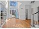 Welcoming foyer featuring hardwood floors, high ceilings, staircase and ample natural light from the front door at 11911 Farnborough Rd, Huntersville, NC 28078