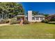 Charming ranch home with a covered carport and well-manicured lawn at 1304 Armstrong Ford Rd, Belmont, NC 28012