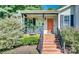 Inviting front porch with brick steps, hanging plants, and stylish door at 1304 Armstrong Ford Rd, Belmont, NC 28012