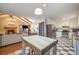 Kitchen features a farmhouse table, checkerboard floor, and white cabinets at 1304 Armstrong Ford Rd, Belmont, NC 28012