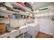 Convenient laundry room with washer, dryer, and shelving at 1304 Armstrong Ford Rd, Belmont, NC 28012